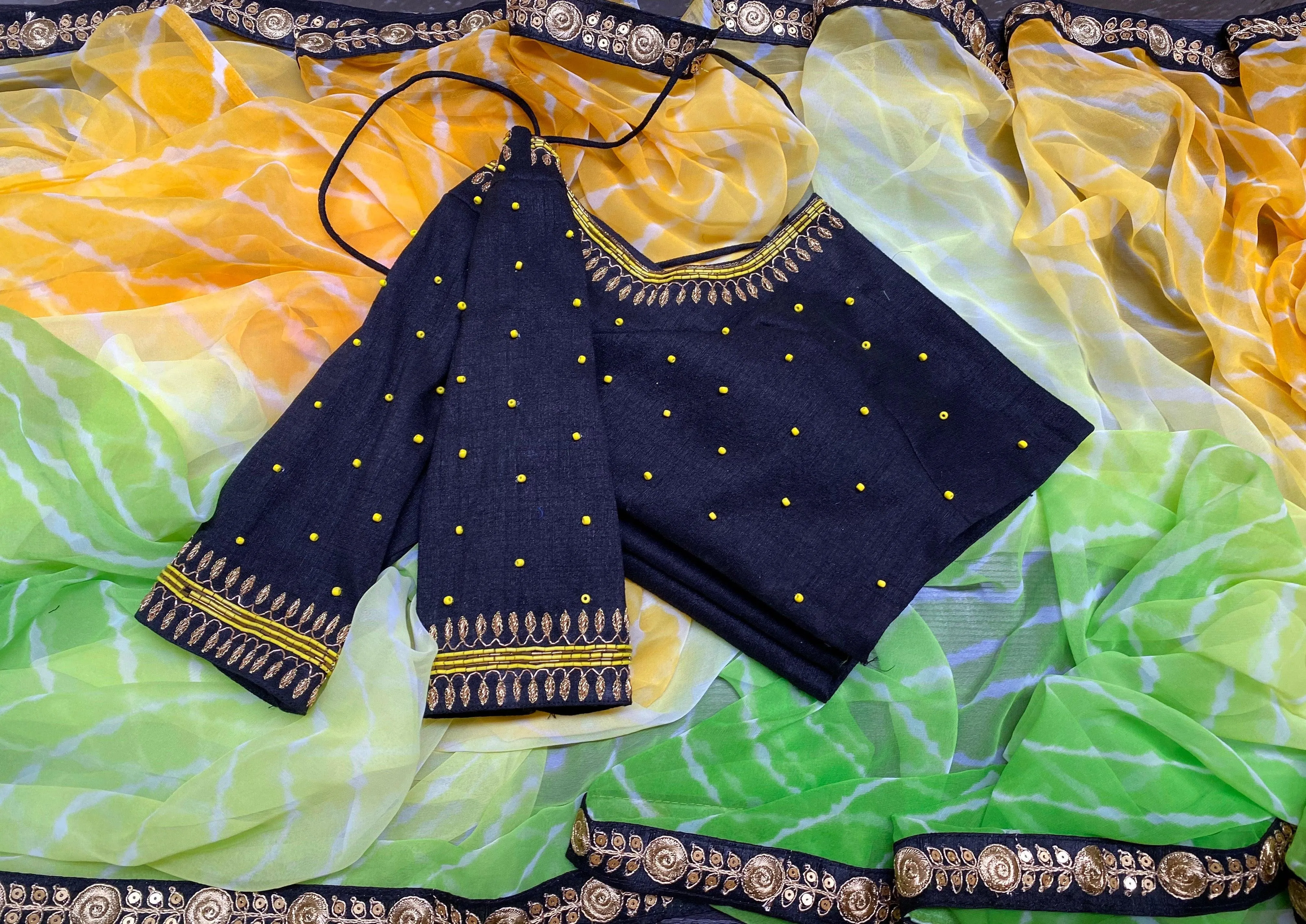 Tie and die green and yellow saree with aari work blouse